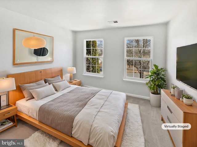 bedroom with carpet floors, visible vents, and baseboards