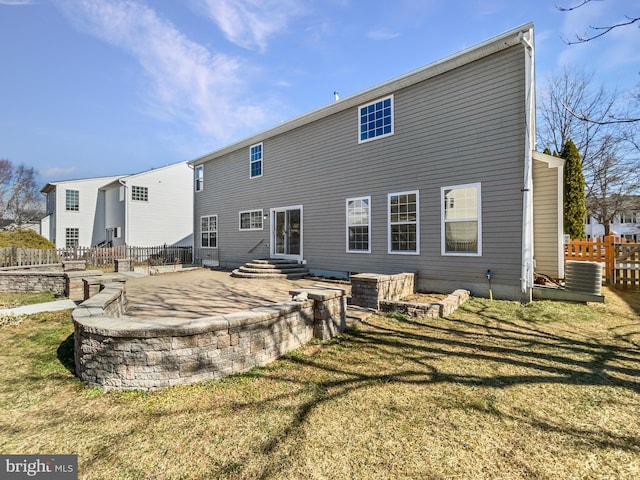 rear view of property with central air condition unit, a yard, fence, and a patio