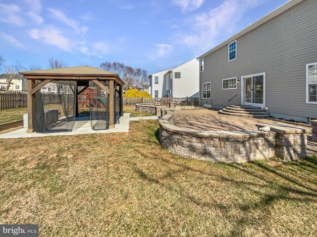 view of yard featuring entry steps, a gazebo, a patio area, and fence