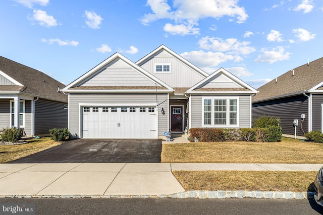 view of front of house with a garage, driveway, and board and batten siding