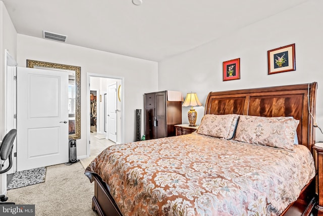 bedroom featuring visible vents and light carpet