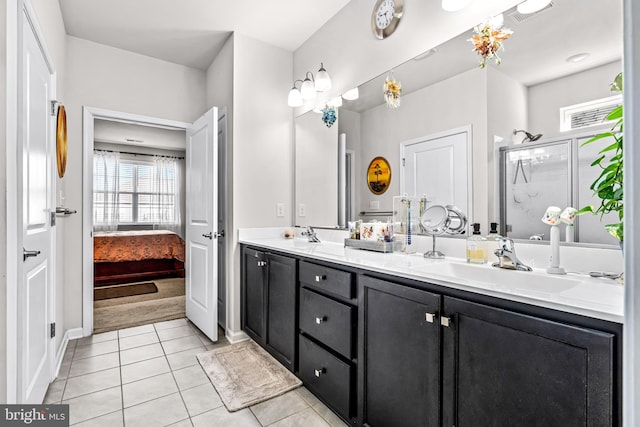 ensuite bathroom with double vanity, visible vents, ensuite bathroom, tile patterned flooring, and a sink