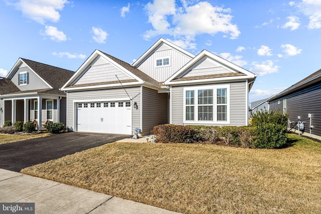 view of front of property with an attached garage, a front lawn, aphalt driveway, and board and batten siding