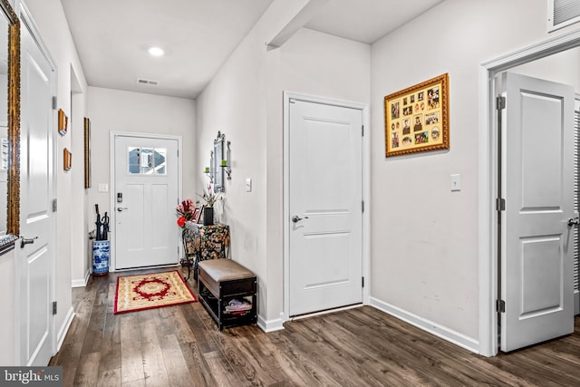 entryway featuring dark wood-style flooring, visible vents, and baseboards