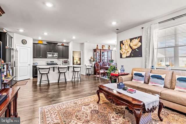 living room featuring dark wood-style floors and recessed lighting