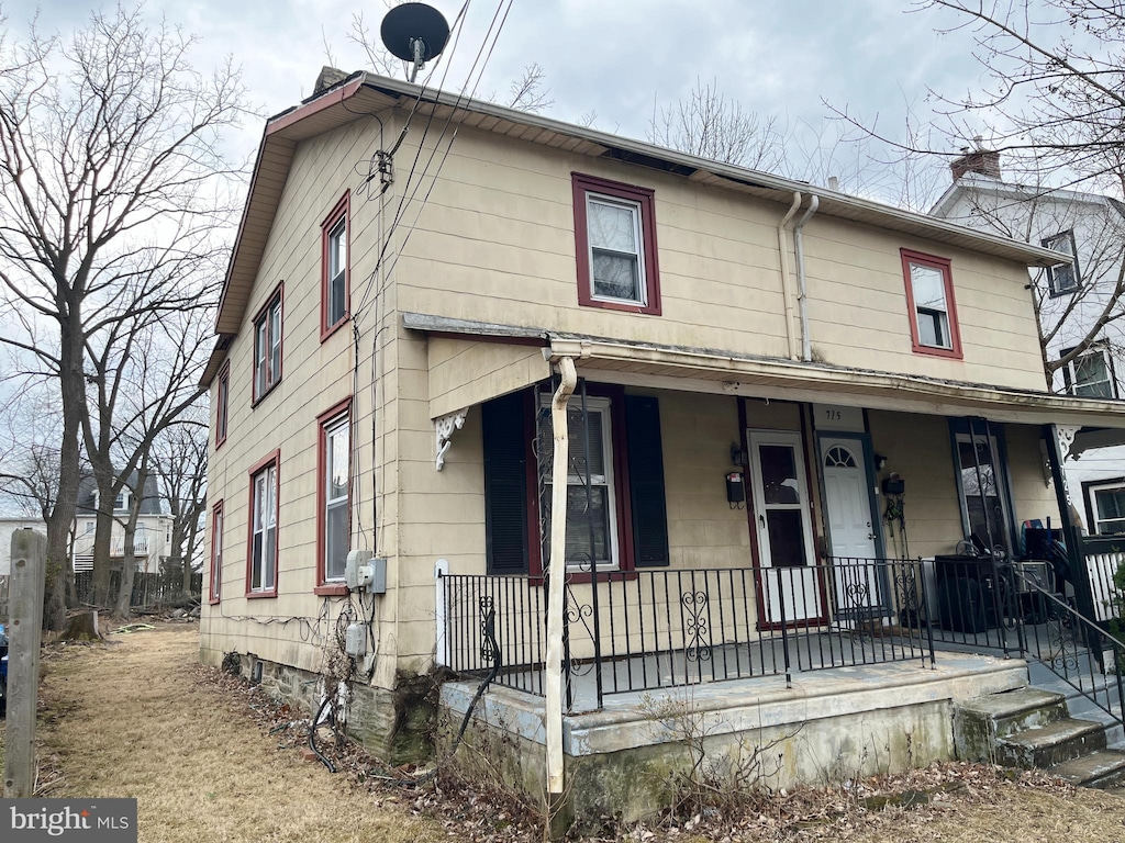 view of front of home with covered porch and a chimney