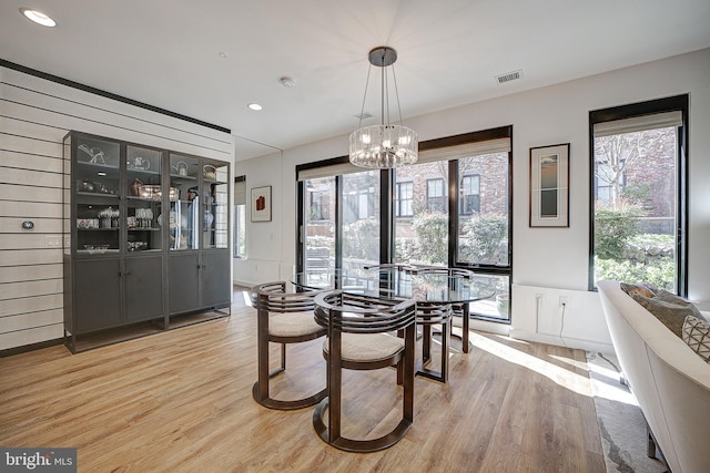 dining space with light wood-type flooring, visible vents, a notable chandelier, and recessed lighting