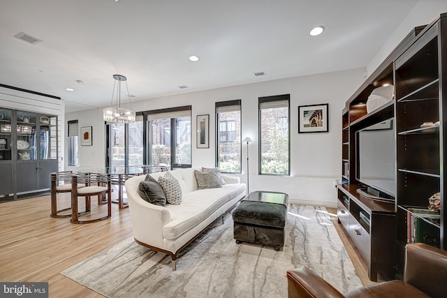 living room with visible vents, light wood-style flooring, and recessed lighting