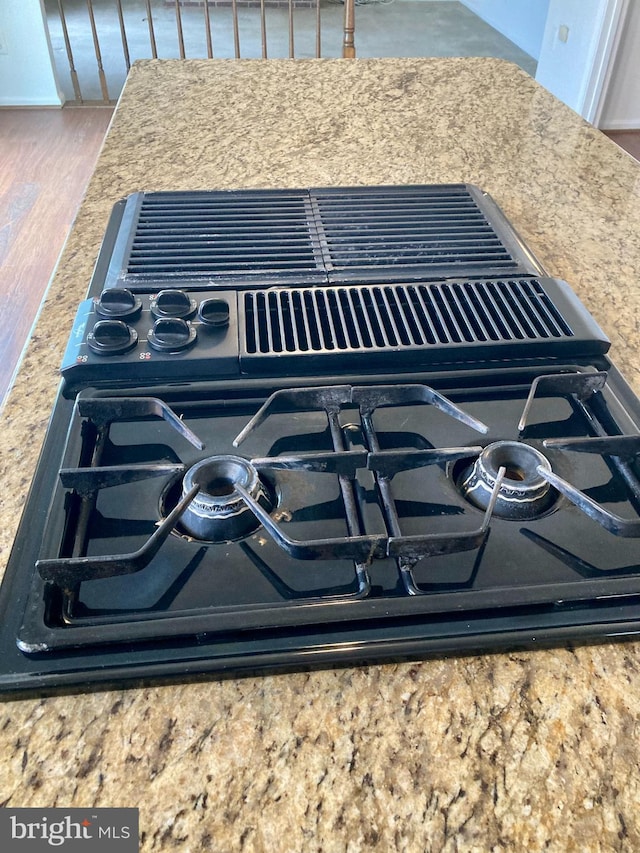 room details featuring stovetop with downdraft and wood finished floors