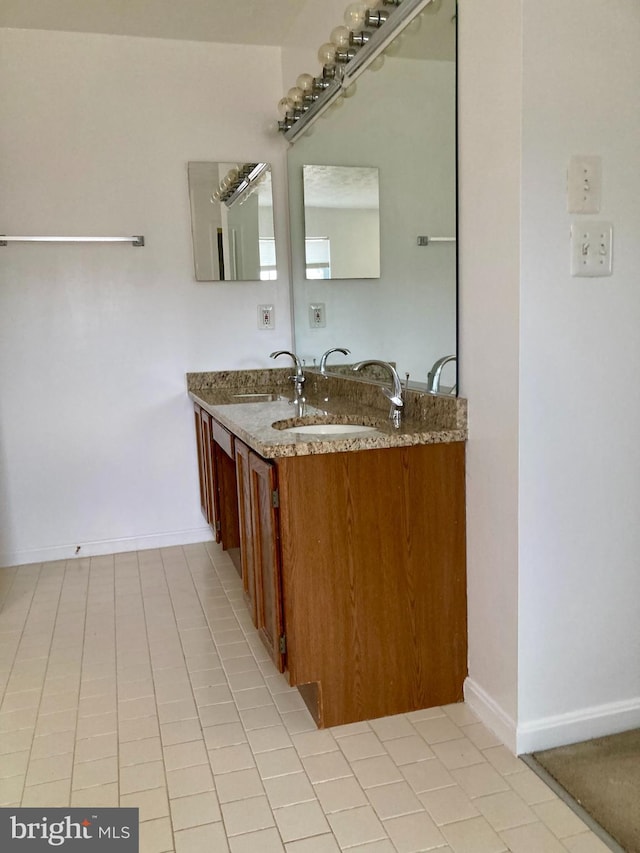 bathroom featuring vanity and baseboards