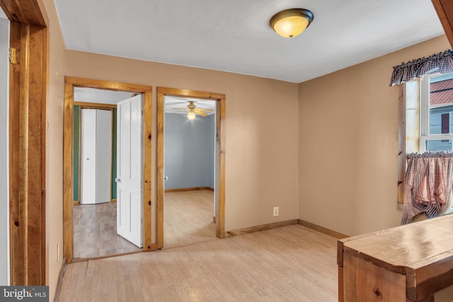 unfurnished room featuring light wood-style flooring and baseboards