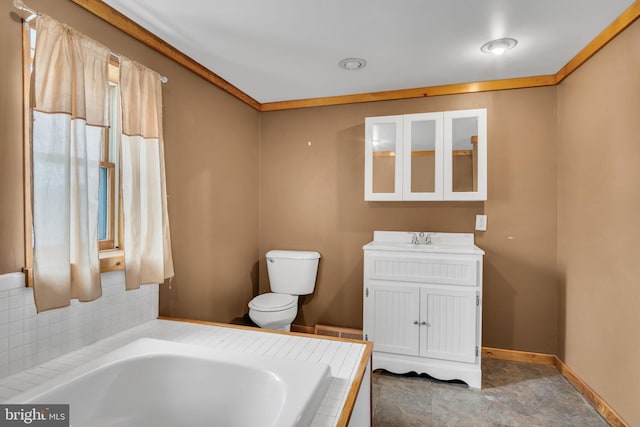 full bathroom featuring baseboards, a garden tub, vanity, and toilet