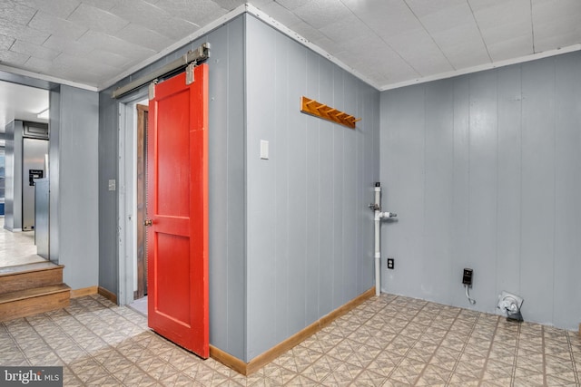 corridor featuring baseboards and tile patterned floors