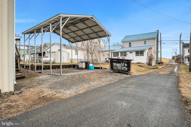 view of parking / parking lot featuring a carport and driveway