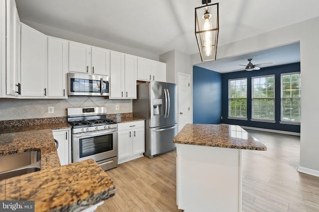 1332 Cranes Bill Way, Woodbridge, VA 22191 - kitchen with appliances with stainless steel finishes, a center island, backsplash, and white cabinets