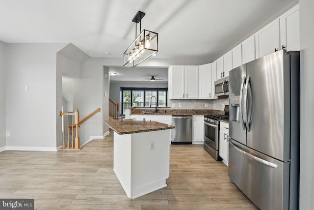 1332 Cranes Bill Way, Woodbridge, VA 22191 - kitchen featuring appliances with stainless steel finishes, white cabinets, dark stone countertops, ceiling fan, and light wood-style flooring
