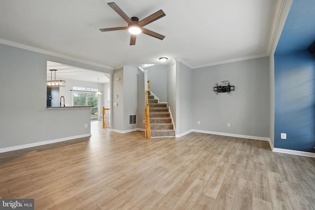 1332 Cranes Bill Way, Woodbridge, VA 22191 - unfurnished living room featuring a ceiling fan, ornamental molding, wood finished floors, stairway, and a sink