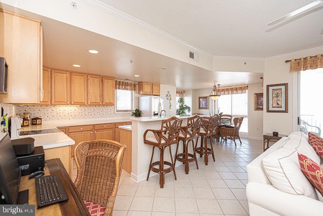 kitchen featuring light tile patterned floors, white refrigerator with ice dispenser, visible vents, light countertops, and ornamental molding