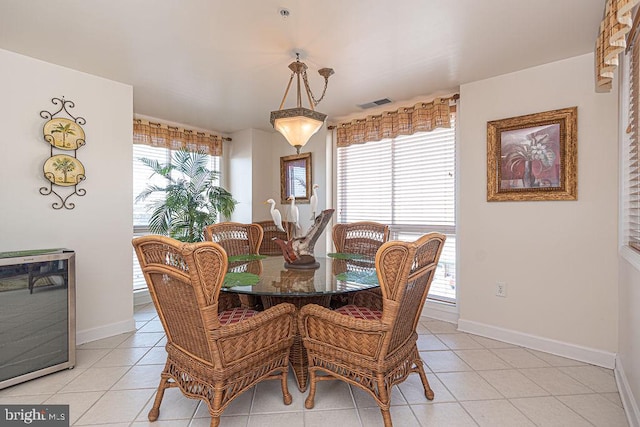 dining space featuring visible vents, a wealth of natural light, and light tile patterned flooring