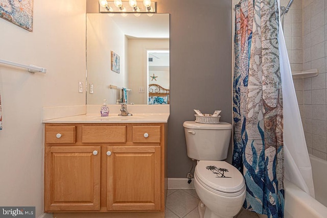 bathroom featuring tile patterned flooring, toilet, vanity, baseboards, and shower / tub combo with curtain