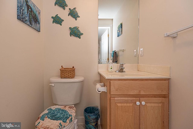 bathroom featuring toilet and vanity