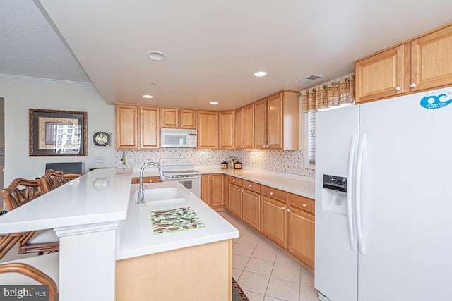 kitchen with white appliances, light tile patterned floors, light countertops, a kitchen bar, and backsplash