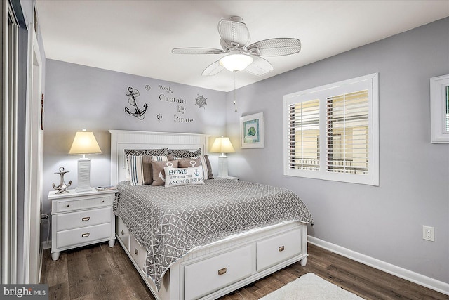 bedroom with dark wood-style floors, baseboards, and a ceiling fan