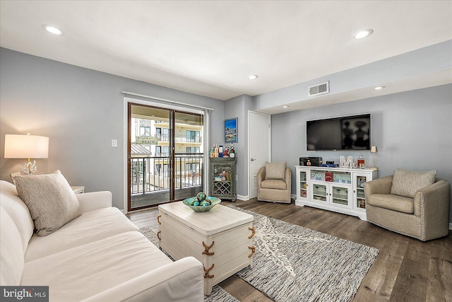 living room with visible vents, wood finished floors, and recessed lighting