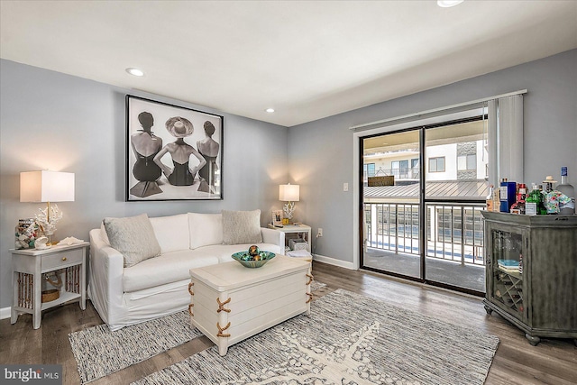 living room featuring recessed lighting, baseboards, and wood finished floors