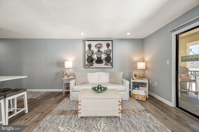 living room featuring recessed lighting, baseboards, and wood finished floors