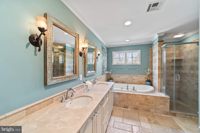 bathroom with visible vents, ornamental molding, a shower stall, and a sink