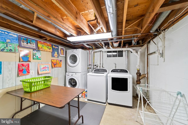 clothes washing area with washer and dryer, laundry area, and stacked washing maching and dryer