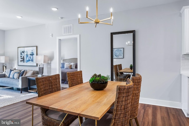 dining room with a notable chandelier, recessed lighting, visible vents, wood finished floors, and baseboards