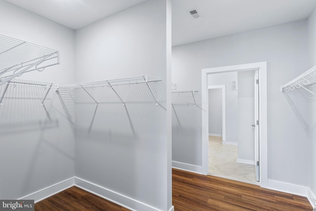 spacious closet with visible vents and wood finished floors