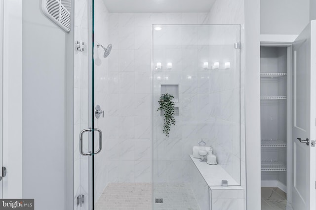 bathroom with a shower stall and visible vents