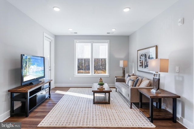 living area with dark wood-style flooring, recessed lighting, visible vents, and baseboards