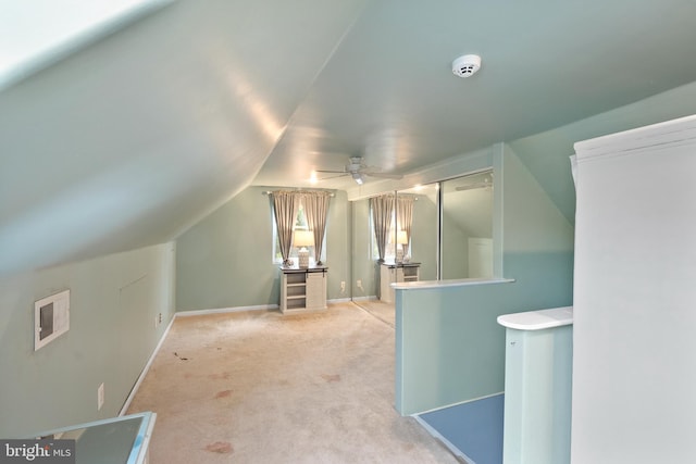 additional living space with vaulted ceiling, carpet floors, a ceiling fan, and baseboards