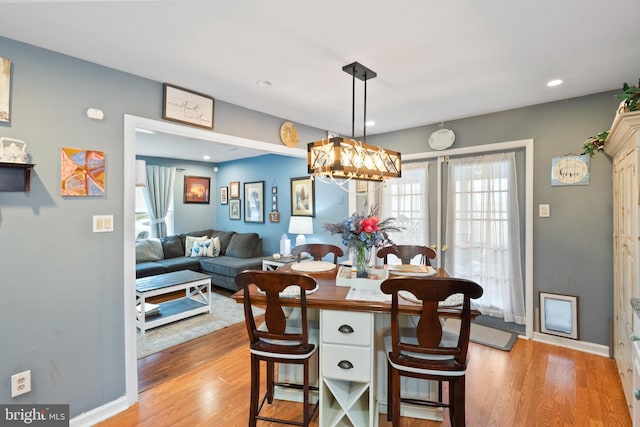 dining area with light wood-type flooring, baseboards, and recessed lighting