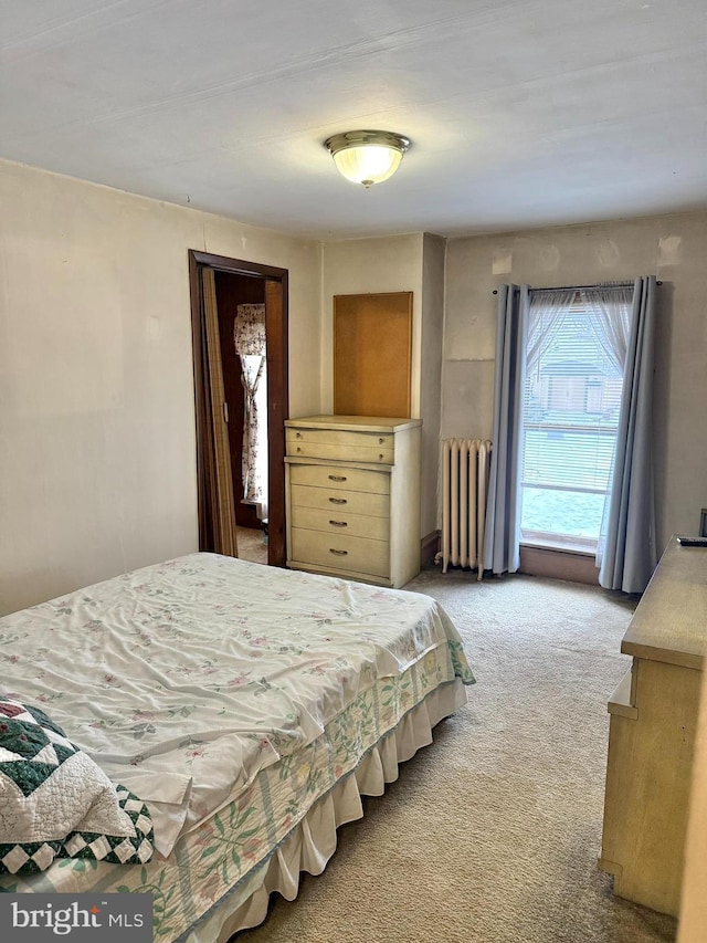 bedroom with light carpet and radiator