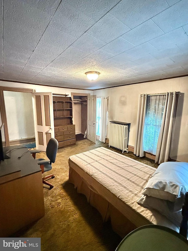 carpeted bedroom featuring a textured ceiling