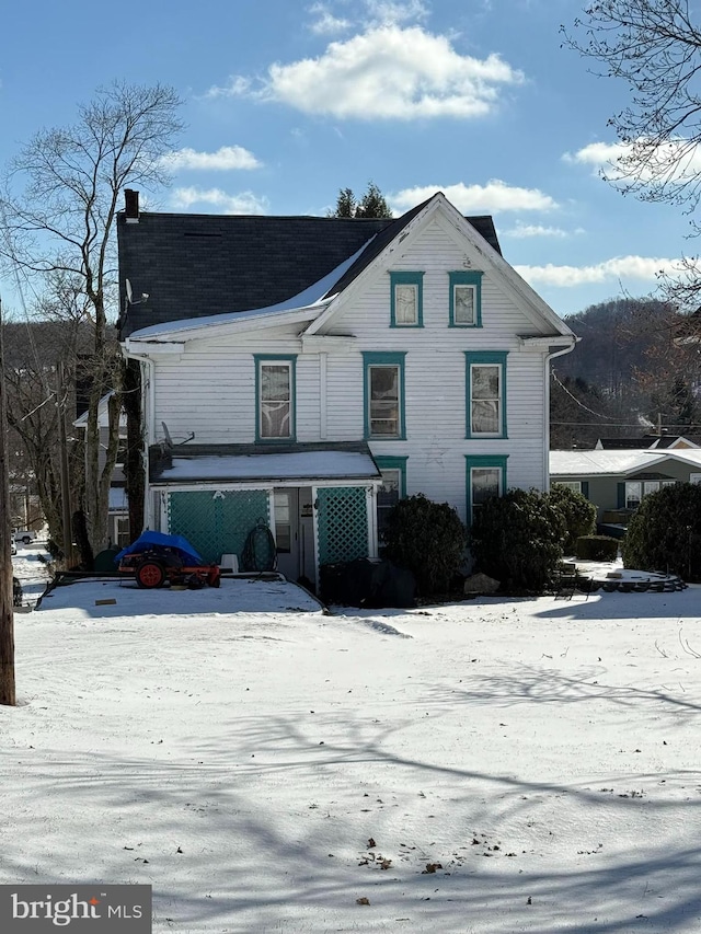 view of front facade featuring a chimney