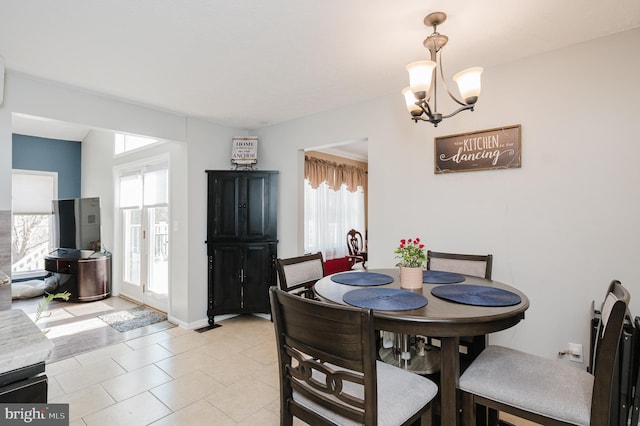 dining area featuring light tile patterned floors, baseboards, and an inviting chandelier