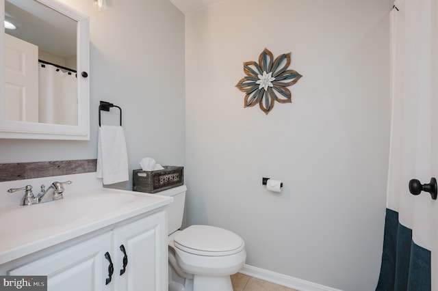 bathroom featuring tile patterned flooring, vanity, and toilet