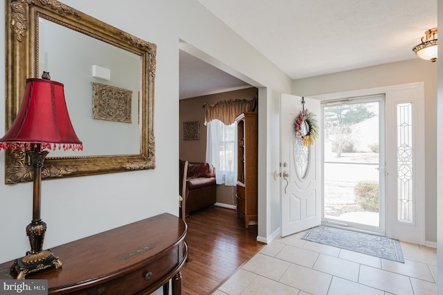 entryway with light wood-style floors and baseboards