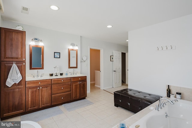 full bathroom featuring recessed lighting, double vanity, a sink, and a bath