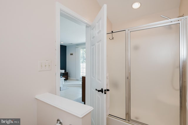 full bathroom with a shower with door and recessed lighting