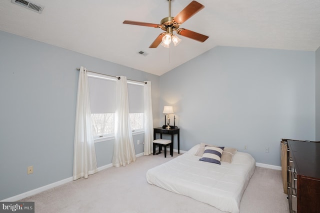 carpeted bedroom with visible vents, vaulted ceiling, baseboards, and ceiling fan