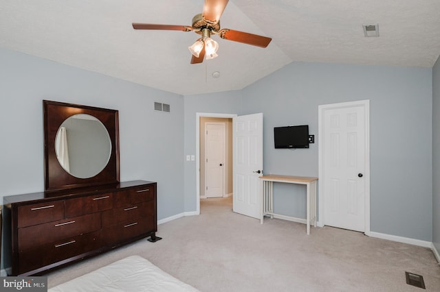 bedroom featuring light colored carpet, a ceiling fan, baseboards, vaulted ceiling, and visible vents