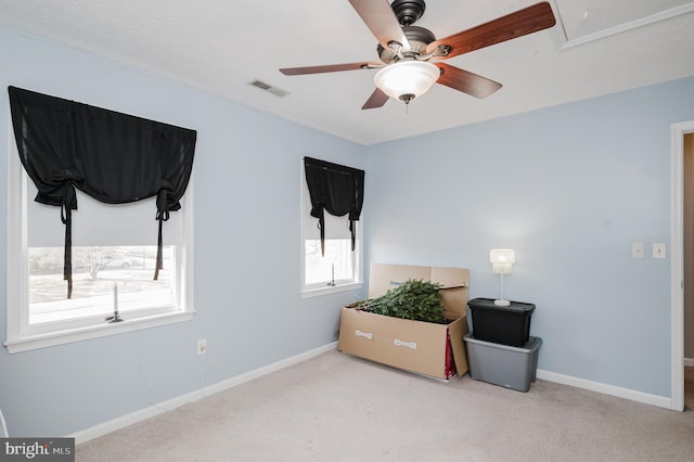 interior space with a wealth of natural light, baseboards, visible vents, and carpet