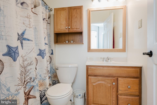 bathroom featuring toilet and vanity